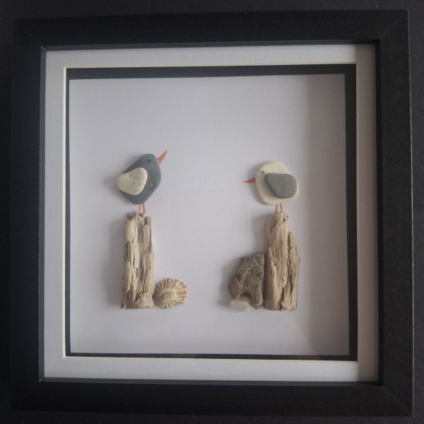 Pebble bird picture in a black shadow box frame