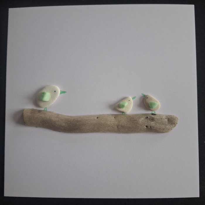 Sea-glass Chicks: three pebble birds with green sea glass wings on a driftwood branch