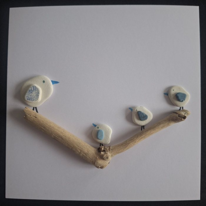 Blue Willow Family: four pebble birds with blue sea pottery wings on a forked branch