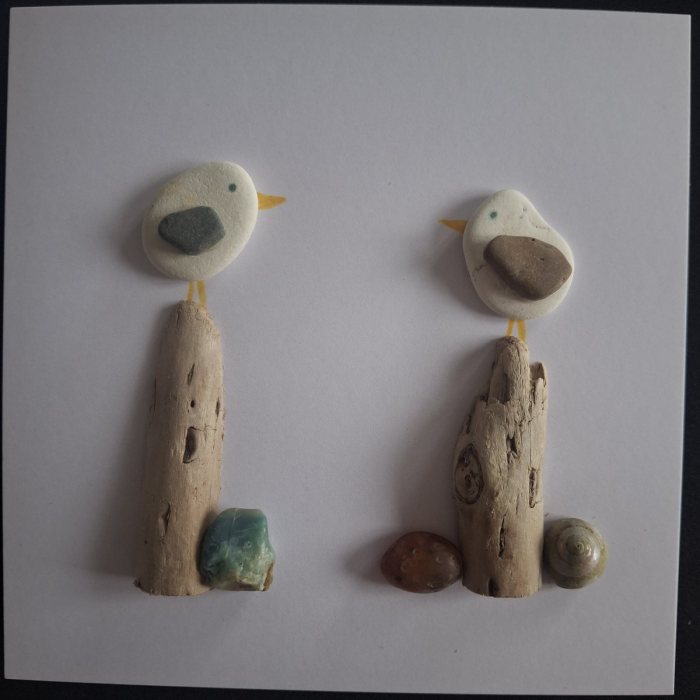Sea-green Stone: two pebble gulls on driftwood posts with a blue-green stone and a spiral shell