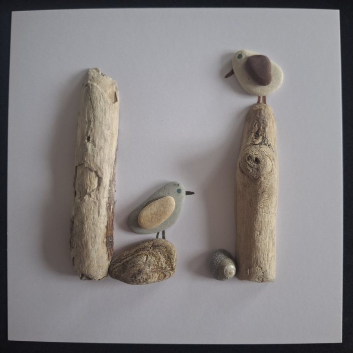 Knot-hole Post: a grey pebble bird on a pebble and a gull on a tall driftwood post